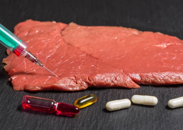 Food scientist injecting raw meat