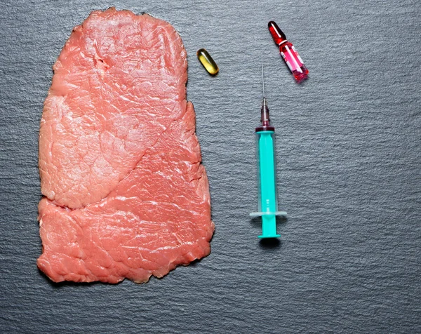 Food scientist injecting raw meat