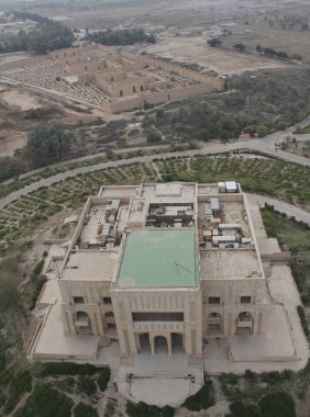 Saddam Hussein's deserted palace in Babylon in Iraq seen from air. Restored ruins of the ancient Babylon on the background. clipart