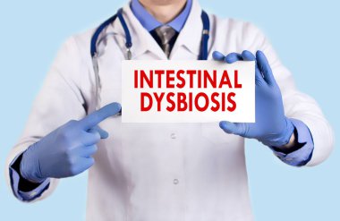 Doktor bağırsak dysbiosis adını taşıyan bir kartı tutar. Seçici odak. Tıp kavramı.