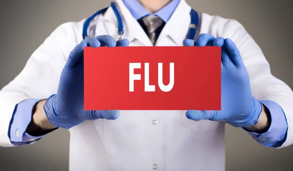 Doctor's hands in blue gloves shows the word flu. Medical concept. — Stock Photo, Image