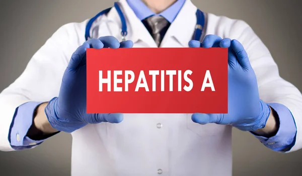 Doctor's handen in handschoenen blauw toont het woord hepatitis a. medische concept. — Stockfoto
