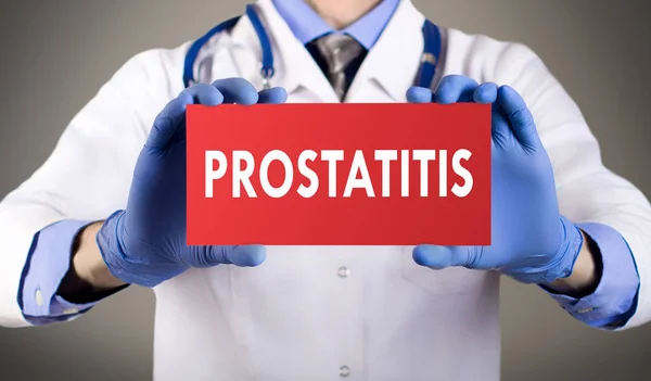 Doctor's hands in blue gloves shows the word prostatitis. Medical concept. — Stock Photo, Image