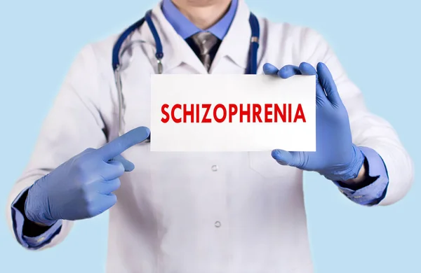 Doctor keeps a card with the name of the schizophrenia. Selective focus. Medical concept. — Stock Photo, Image