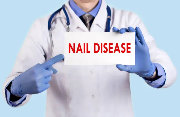 stock image Doctor keeps a card with the name of the nail disease. Selective focus. Medical concept.