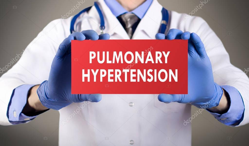 Doctor's hands in blue gloves shows the word pulmonary hypertension. Medical concept.