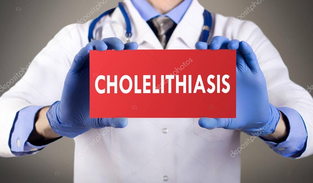 Doctor's hands in blue gloves shows the word cholelithiasis. Medical concept.