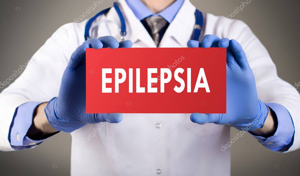 Doctor's hands in blue gloves shows the word epilepsia. Medical concept.