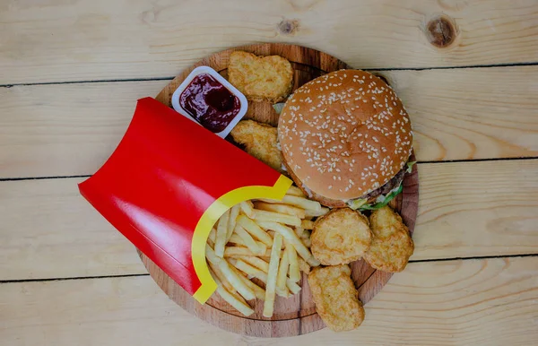 Burger, French fries and the background wood nagets