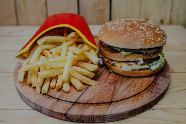 French fries and Burger on wood tray