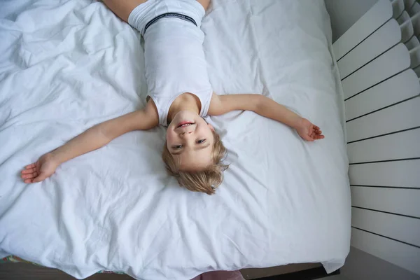 View Little Boy Having Fun Lying White Bed — Stock Photo, Image
