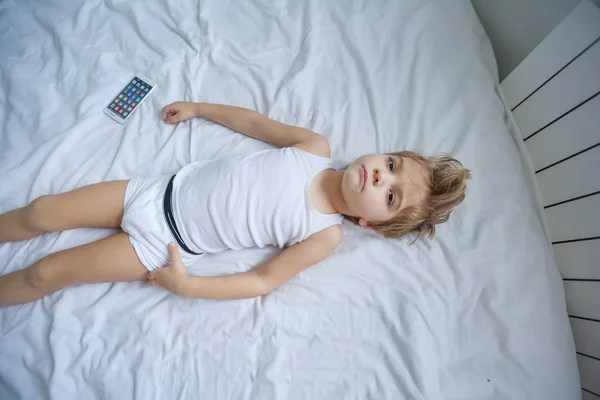 View Little Boy Lying White Bed Smartphone — Stock Photo, Image