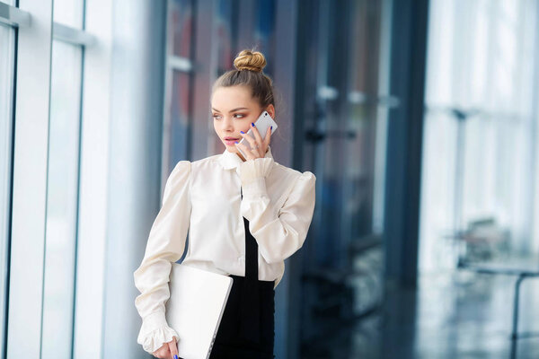 beautiful businesswoman with laptop and phone 