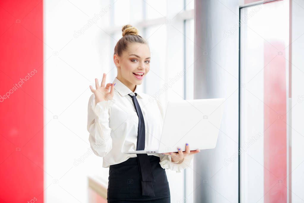 beautiful business woman posing with laptop 