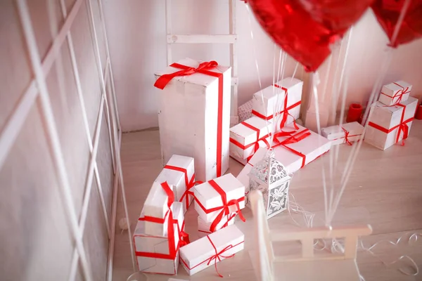 studio decor with gift boxes and red balloons in heart shape