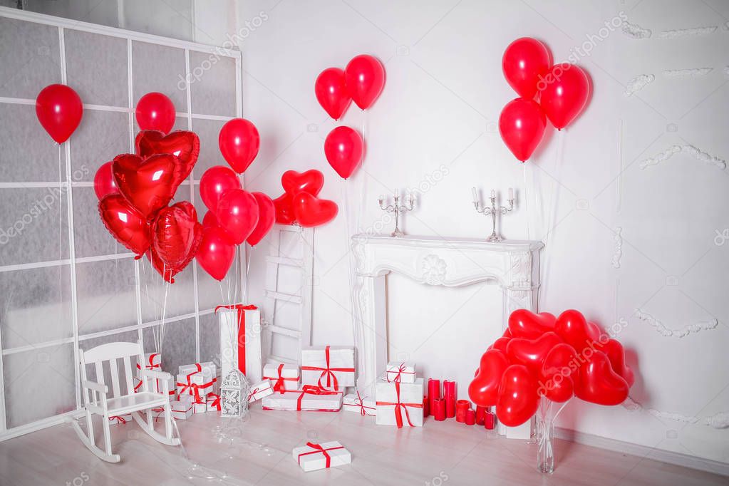 studio decor with gift boxes and red balloons in heart shape 