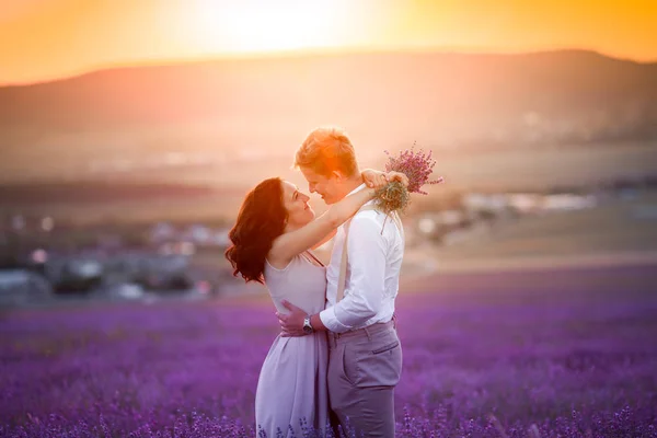 年轻美丽的夫妇摆在薰衣草领域 — 图库照片