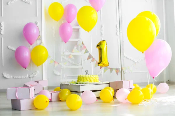 Yellow color concept of festive decorations with cake and candles 1 year