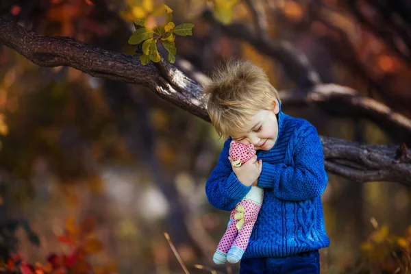 Beautiful little boy in autumn forest holding his favorite toy — 스톡 사진