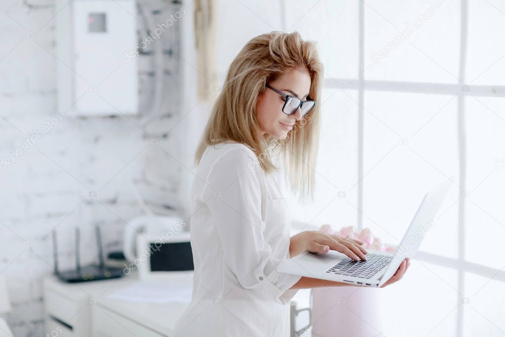 Woman businesswoman in glasses works in the office
