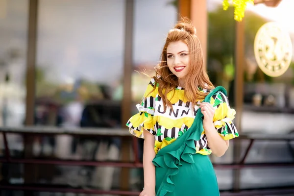 A woman walks down the street along tourist cafes in bright attractive clothes — Stock Photo, Image