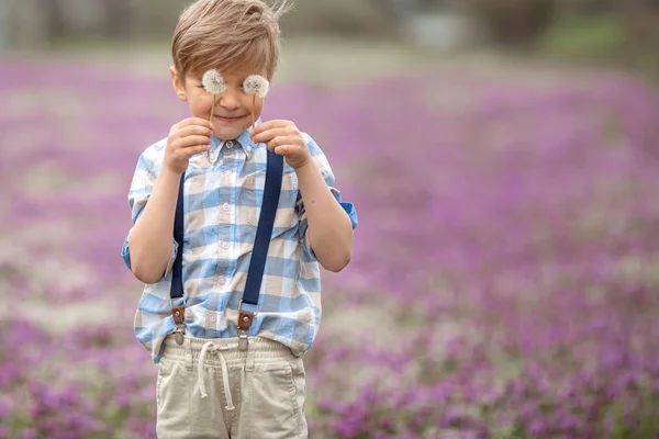 A child with dandelions in his hands