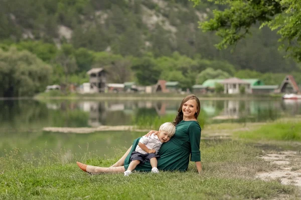 Schwangere bei einem Sommerspaziergang außerhalb der Stadt am See der Berge und Wälder — Stockfoto