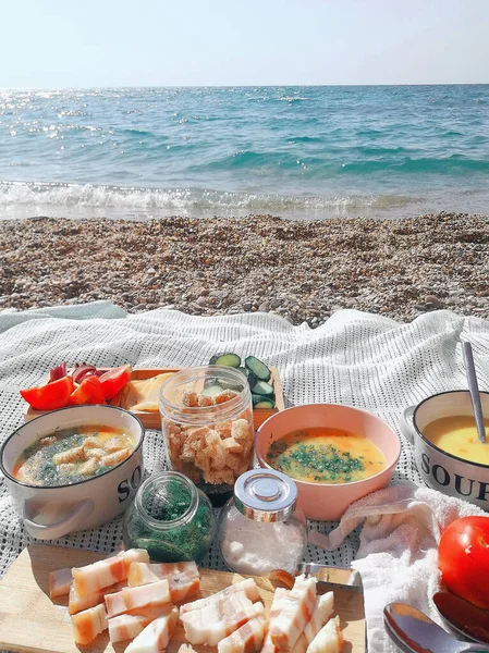 Lunch on the sea coast of broth with breadcrumbs and slices of b