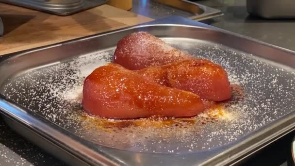 Male chef caramelizes a tomist pear on a metal vessel — Stock Video