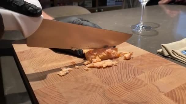 Male chef slices slate of slate salmon fillet on wooden board — Stock Video