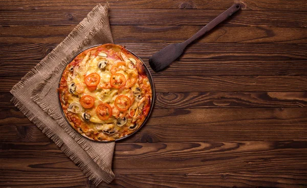 Tahta bir masada pizza.