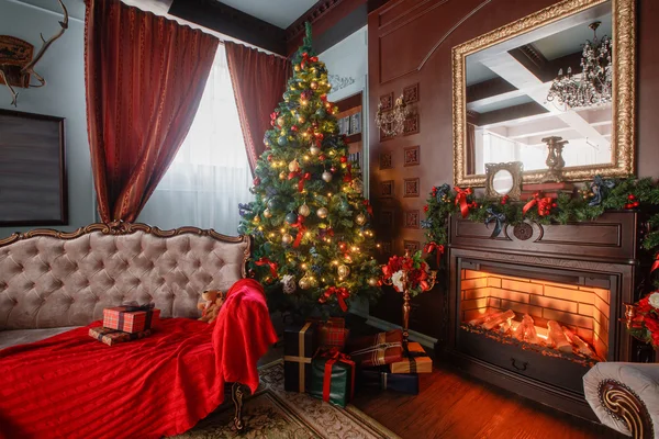 Christmas morning. classic apartments with a white fireplace, decorated tree, sofa, large windows and chandelier.