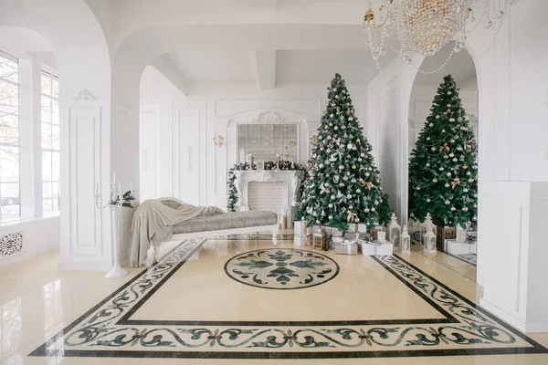 Mañana de Navidad. apartamentos de lujo clásicos con chimenea blanca, árbol decorado, sofá luminoso, grandes ventanales —  Fotos de Stock