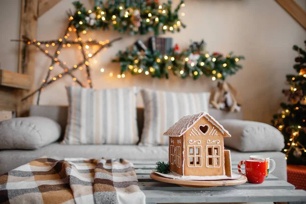 Hausgemachte Lebkuchenhaus im Hintergrund Zimmer für Weihnachten dekoriert. — Stockfoto