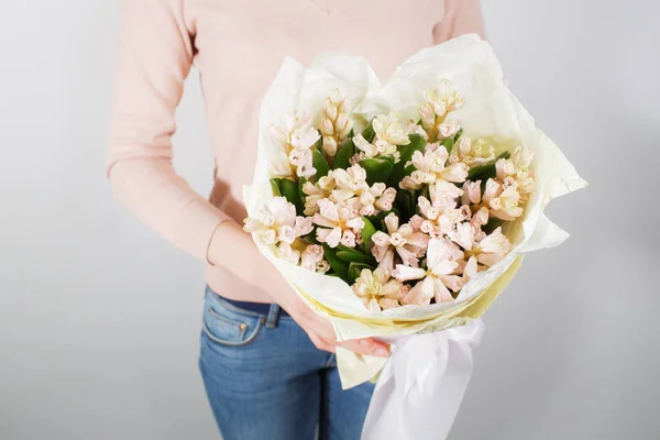 Florist at work. Make bouquet hyacinth. Bunch in their hands