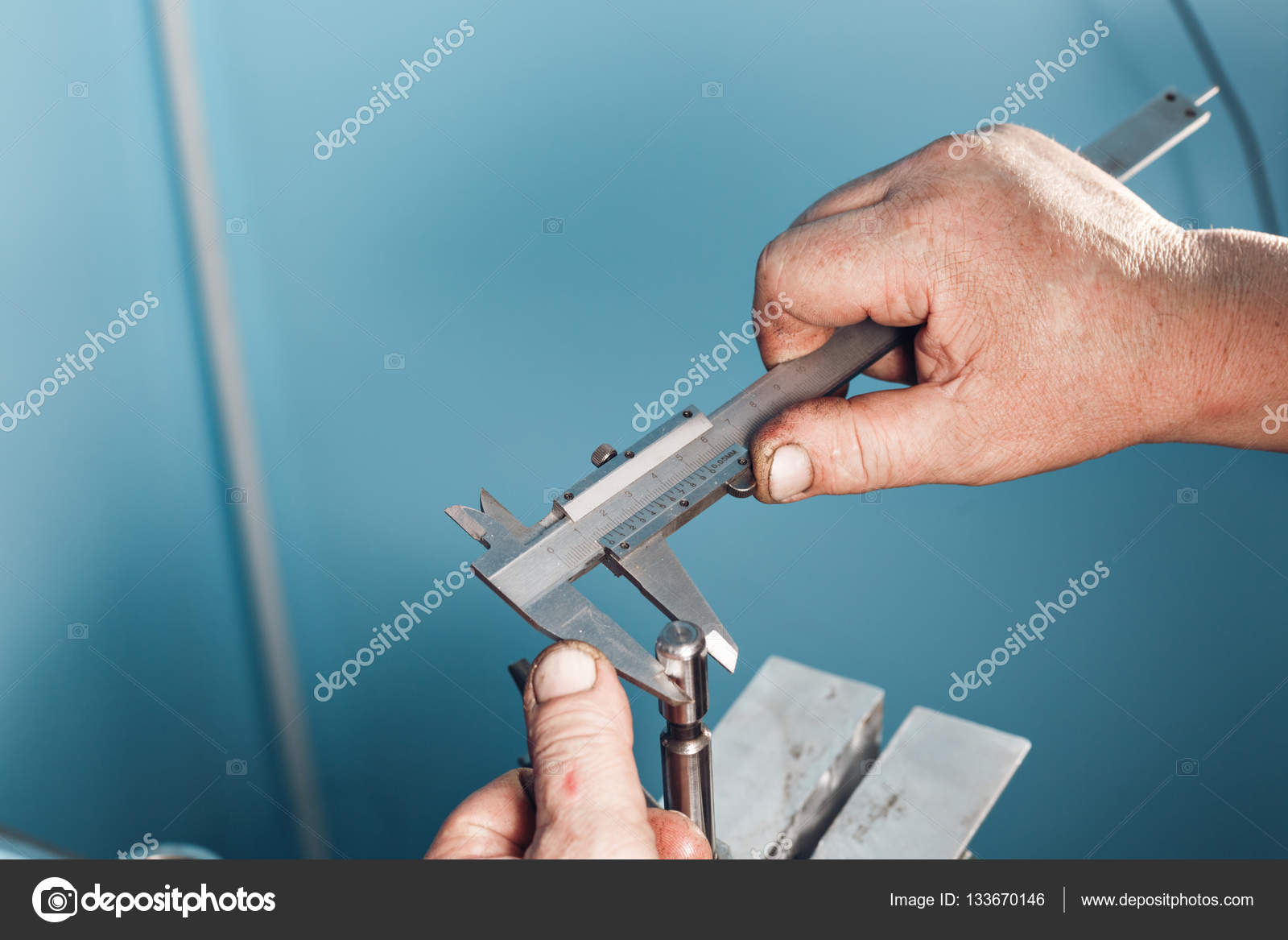 Mechanical technician worker hands measuring detail tool after