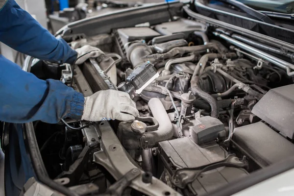 Mechanik ręce sprawdzenie serwisowanie samochodu w pokrywa silnika, z bliska — Zdjęcie stockowe