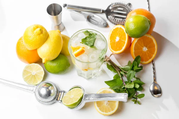 Bebida de verão. Limonada tradicional com hortelã-limão e gelo na mesa branca. Vista superior com foco suave — Fotografia de Stock