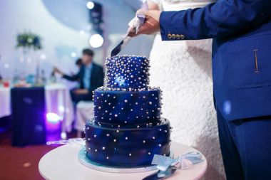 Gelin ve damat mavi düğün pastanı kesme.