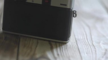 Vintage fotoğraf makinesi, objektif ve ahşap masa filmde. Masaya vurduğu için ekipman. Kaymak