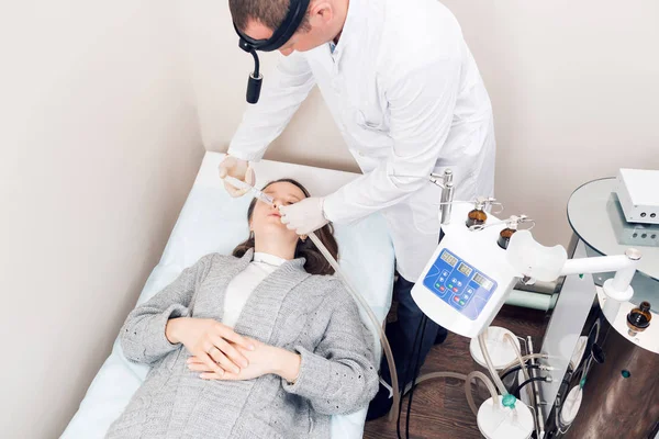 ENT arts op zoek naar patiënten oor met een instrument. privé kliniek. otolaryngologist — Stockfoto