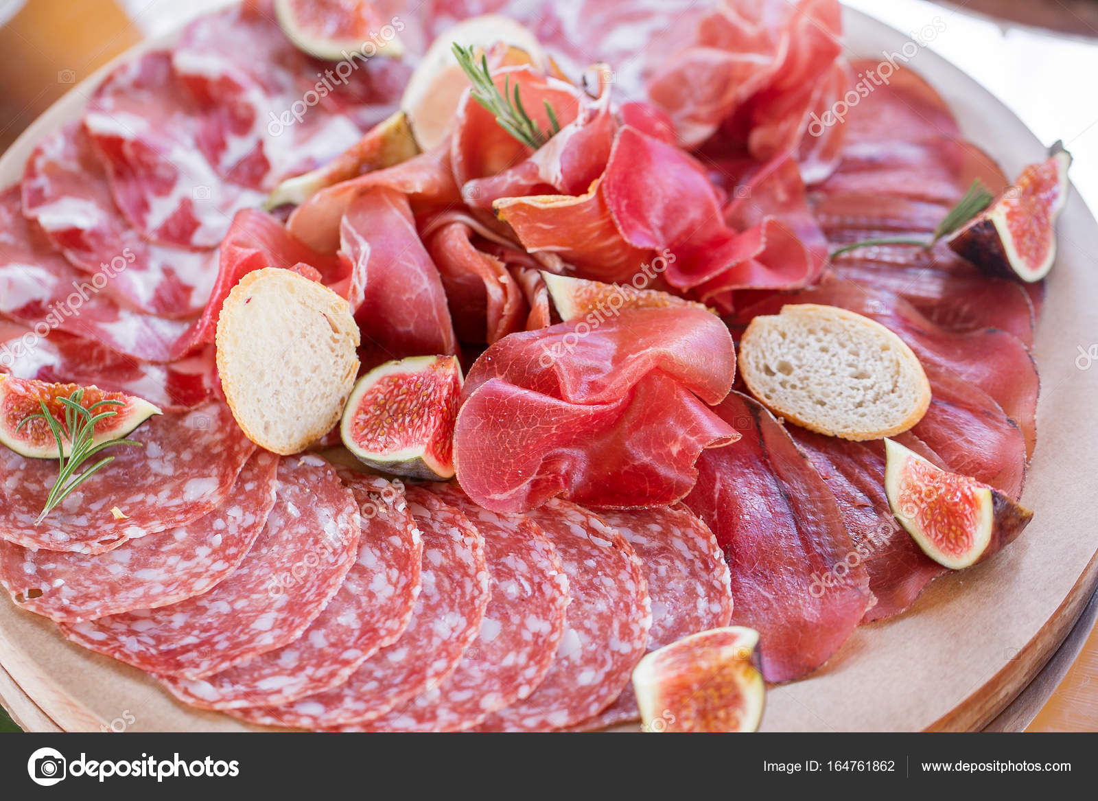 Italian antipasti and appetizers. board with slices prosciutto, salami