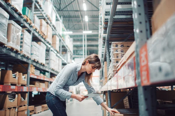 Stock taking. beautiful young woman worker of furniture store. — Stock Photo, Image