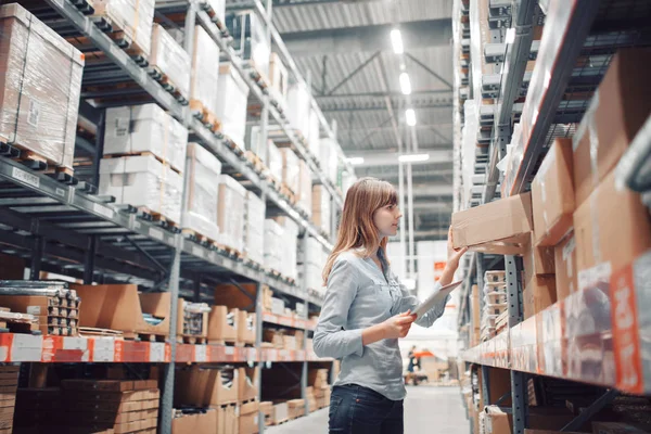 Stock taking. beautiful young woman worker of furniture store. — Stock Photo, Image