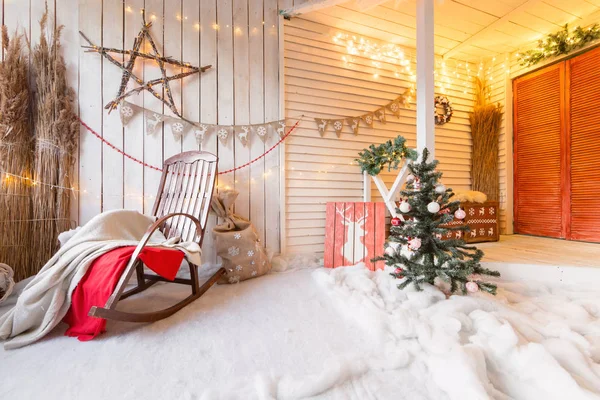 Noel sabahı. Sallanan sandalye süslemeleri yakacak odun ve ahşap duvar ile — Stok fotoğraf