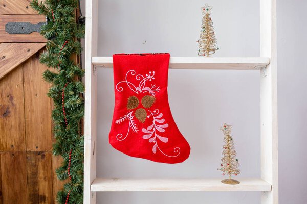 red christmas sock hanged above white stairs in room