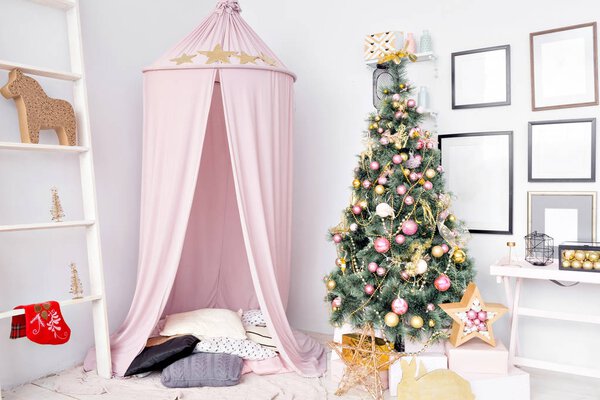 Hovel prepared for children. Beautiful New Year decor of the children room Christmas house.