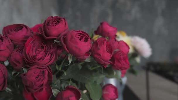 Close up red blooming roses. Flowers at flower shop, workshop. Floristry, handmade and artwork concept — Stock Video