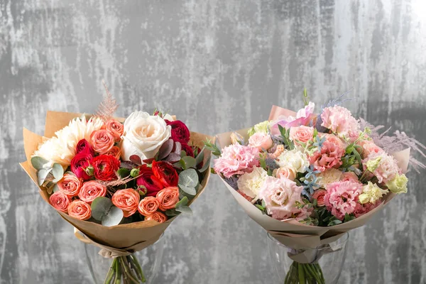 stock image two beautiful luxury bouquet of mixed flowers in glass vase . the work of the florist at a flower shop