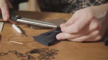 iplik kesti. Yakın çekim yünden bir kelebek kravat şeklini oluşturur. Bir terzi çalışan ve bir dikiş makinesi bir tekstil Studio'yu kullanarak iyi görünümlü genç adam.